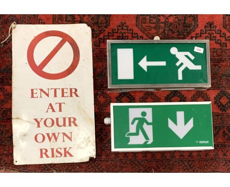 An enamel 'Enter at your own risk' sign, 60cmL, together with 2 emergency exit signs 