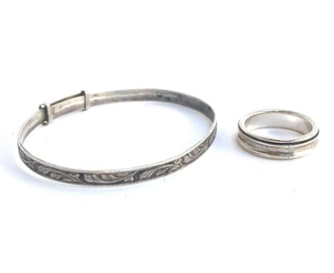 A silver bracelet with floral design, marked W.J.S, approx. 5.8g; together with a 925 silver swivel ring, approx. 4.4g, size 