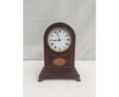 An Edwardian arch clock on bracket feet