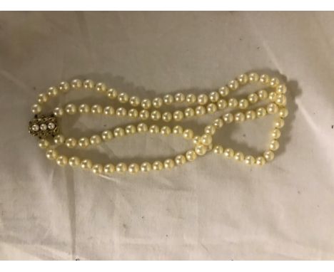 A 9ct pearl and ruby clasped pearl necklace