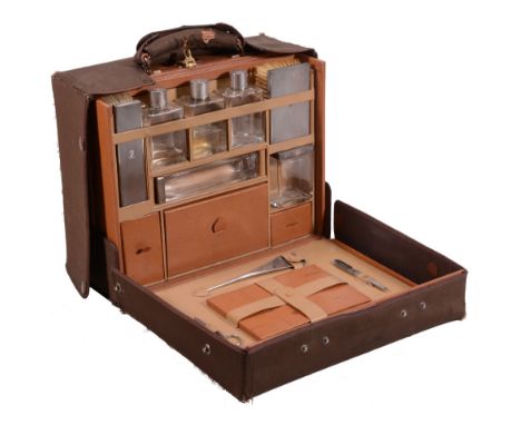 A pigskin rectangular travelling case with silver fittings by Asprey & Co  A pigskin rectangular travelling case with silver 