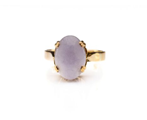 A 9ct gold and lavender jade ring, the oval, cabochon-cut jade in an ornately carved basket setting, ring size M.