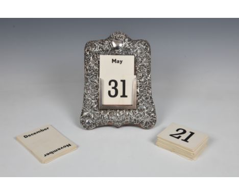 A Victorian silver easel back perpetual calendar, James Deakin &amp; Sons, Chester, 1899, of shaped rectangular form, heavily