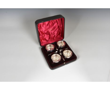 A cased set of four Edwardian silver caldron salts, Walker and Hall, Sheffield, 1902 with matched spoons by Harrison Brothers