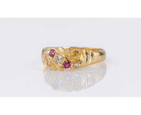 A late-Victorian 22ct gold, ruby and diamond ring, Samuel Hope, Birm. 1899, the scroll carved face set to the diagonal with t