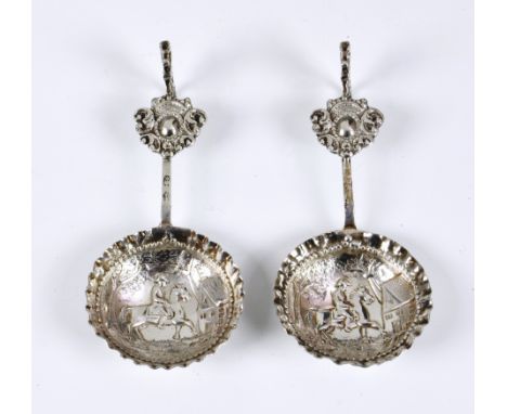 A pair of Continental white metal wine taster / caddy spoons, indistinct marks, the bowls embossed with horse and rider, the 