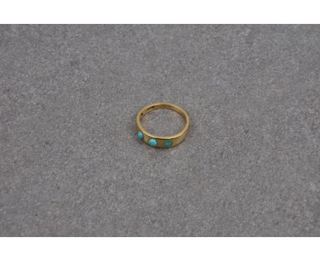 An 18ct gold and turquoise three stone ring, hallmarked 'IB 18CT', the plain band inset with three graduated turquoise caboch