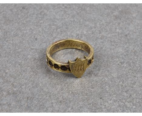 A Victorian 9ct gold mourning ring, the pierced band inset with plaited hair, headed by a shield with engraved monogram, the 