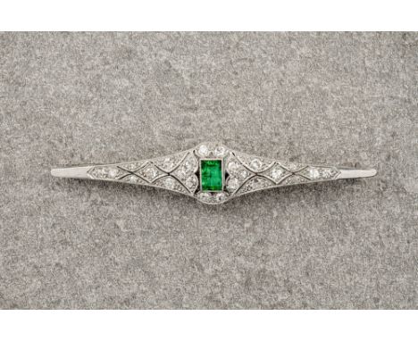 An Art Deco style platinum, diamond and emerald brooch, the central step cut emerald of deep, green colouring and surrounded 