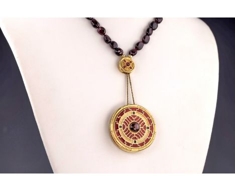 A garnet, enamel and gilt metal archaeological style pendant necklace, retailed by Liberty, the large gilt metal, enamel and 
