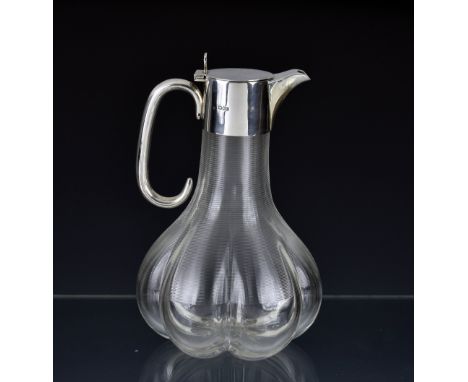 An elegant and unusual late Victorian silver mounted claret jug, William Hutton &amp; Sons Ltd, London 1898, of six-lobed sha