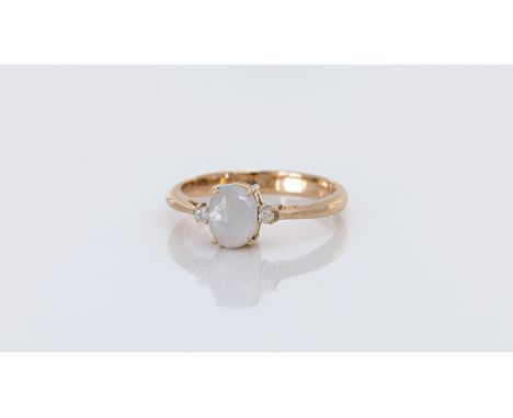 A 14ct gold, white star sapphire and diamond three stone ring, stamped '585', the 7 x 5mm. star sapphire, approx. 1.32ct, fla