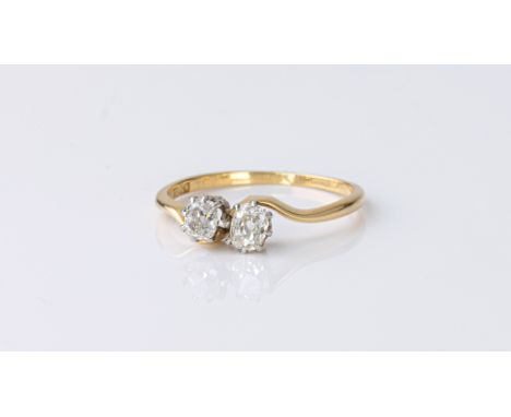 An antique 18ct gold and diamond 'toi et moi' ring, the twist setting with two cushion cut diamonds, approx. 0.50ct in total,