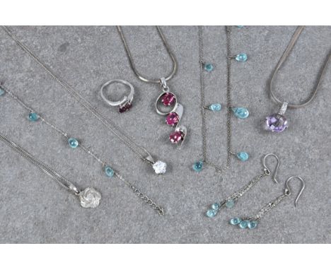 A collection of silver jewellery, comprising a silver, garnet and diamond heart crossover ring, size O; a silver and diamond 