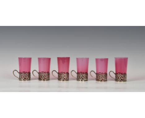 A set of six Victorian silver and cranberry glass beakers, William Hutton &amp; Sons Ltd., London 1897, the pierced scrollwor