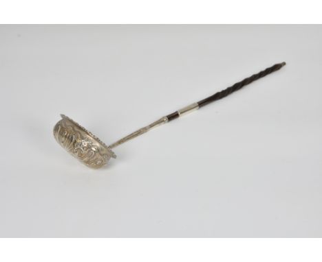 A Georgian silver toddy ladle, no hallmarks, initialled 'MC', of typical form with oval bowl, having repoussé decorated folia