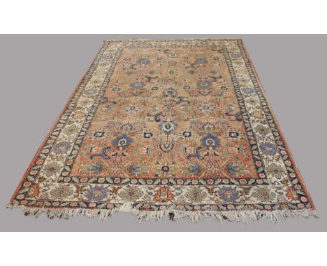 TABRIZ CARPET, Iranian Azerbaijan, circa 1950, the terracotta field with an all over palmette and vine design enclosed by sim