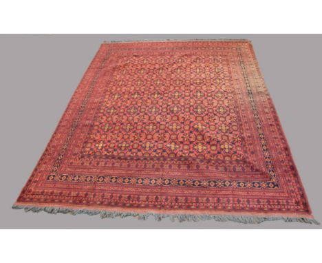 MODERN AFGHAN BESHIR CARPET Afghan Turkestan, the madder field with an allover design of stylised flower heads enclosed by mu