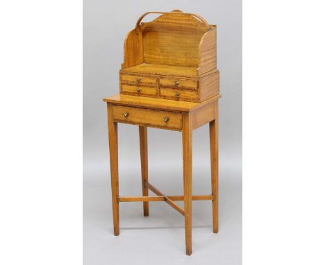 SHERATON RIVIVAL SATINWOOD BOOK TABLE, circa 1900, the removable book trough above four small drawers, the base with one long