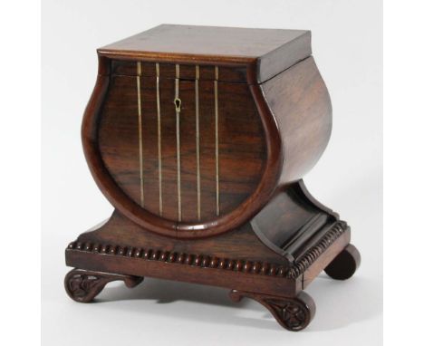 REGENCY ROSEWOOD TEA CADDY of lyre form with brass inlaid 'strings', hidden drawer to one side and scroll feet, height 21cm, 