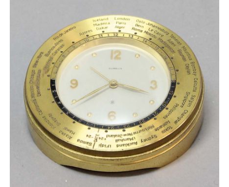 GUBELIN BRASS DESK CLOCK, the 2 3/4" dial inside a bezel marked with world time zones, on an eight day movement with alarm, d
