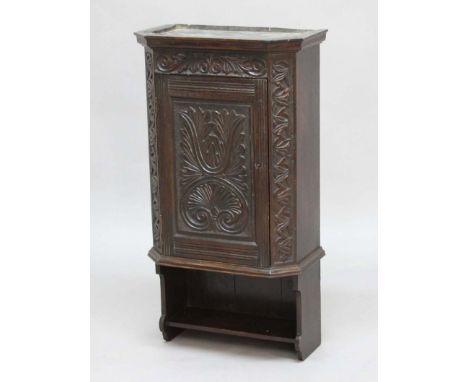 VICTORIAN OAK HANGING WALL CUPBOARD, the foliate carved door above a single shelf, height 90cm, width 48cm, depth 26cm