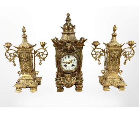 An impressive 19th century gilt metal clock garniture, striking on a gong, with pendulum and key, height 41cm. 