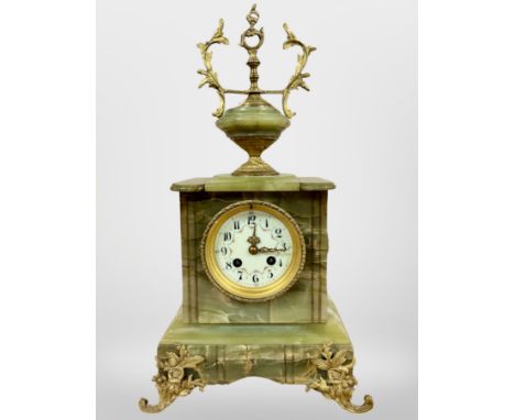 A 19th century onyx and gilt metal mounted eight day mantel clock, striking on a gong, with pendulum and key, height 46cm. 