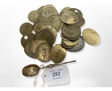 Thirty six vintage railway tokens, together with an ornate silver gilt teaspoon.  (37) 
