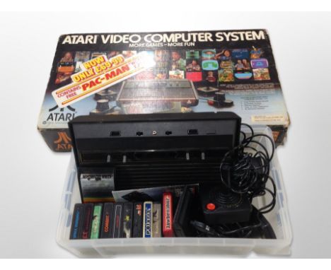 An Atari video games system with joy stick, various games 