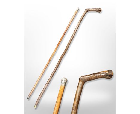 An antique silver-mounted walking cane, length 90cm, and a further hazelwood walking stick.