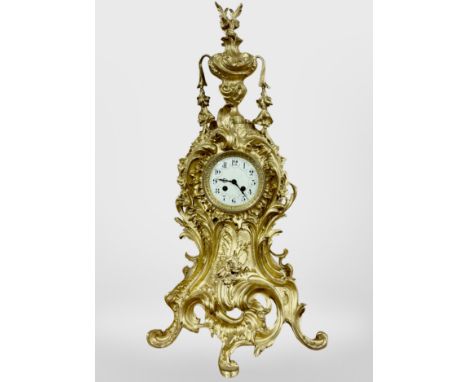 An impressive 19th century Rococo Revival gilt metal eight day mantel clock, striking on a bell, with pendulum and key, heigh