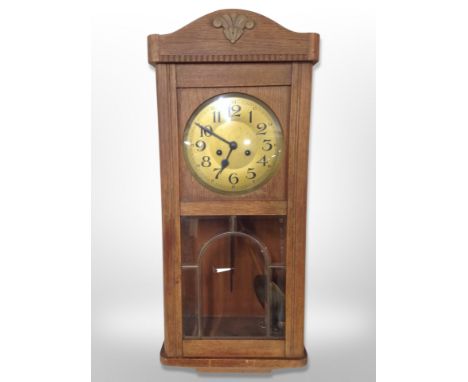 A Continental oak eight day wall clock, height 75 cm