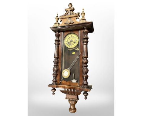 A 19th century Vienna eight day wall clock, with pendulum and key, height 104cm. 