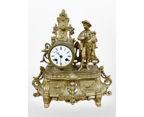 A 19th century French gilt metal figural mantel clock, striking on a bell, with pendulum and key, height 35cm. 