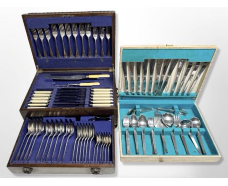 An Edwardian oak canteen of EPNS cutlery, further canteen and a vintage suitcase containing dumbells 