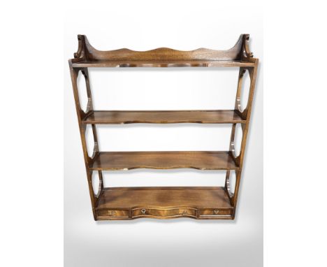 A reproduction mahogany four tier wall shelf, width 69 cm 