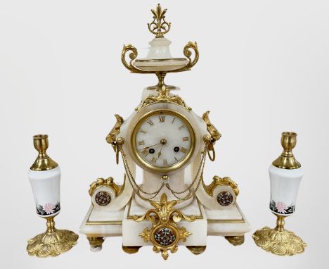 A 19th century French white marble, gilt metal and enamelled mantel clock and a pair of similar candlesticks, striking on a b