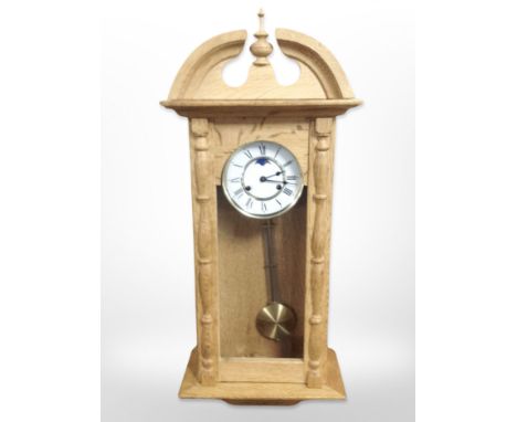A continental blond oak eight day wall clock with moonphase dial, height 80 cm 