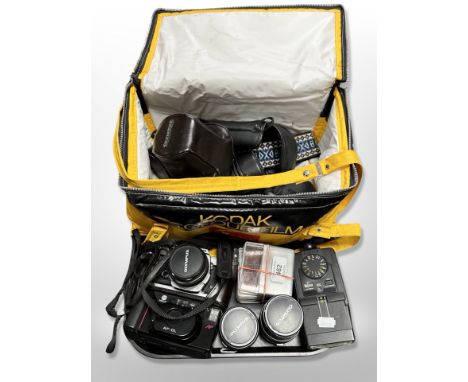 A Kodak camera bag containing assorted cameras and lenses, Olympus OM-1 camera, Minolta AF-DL camera etc 