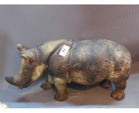 A Ceramic rhino, H: 50cm L: 44cm 