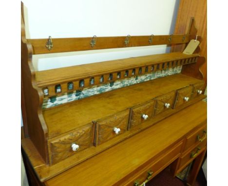 A late 19th / early 20th century Dutch oak spice rack, having six small drawers above blue and white tile backed rack and six