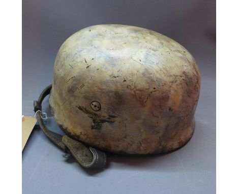 A German Third Reich helmet, bears insignia and label 