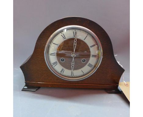 A mid 20th century Benting oak mantle clock, eight day movement, the silvered chapter ring with Roman numerals, raised on bra
