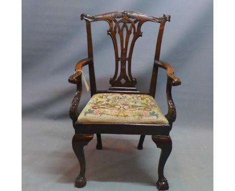 A 19th century Chippendale style mahogany carver armchair with floral tapestry upholstered drop in seat raised on ball and cl