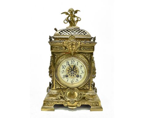 A late 19th century gilt brass eight day mantel clock with Roman numeral chapter ring and movement striking on a gong, the el