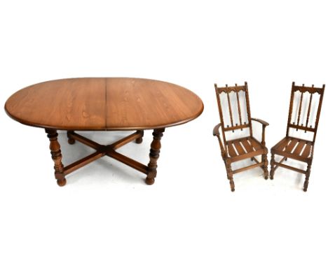 ERCOL; a medium elm D-end extending dining table with extra leaf, raised on column supports, length unextended 158cm, and fou