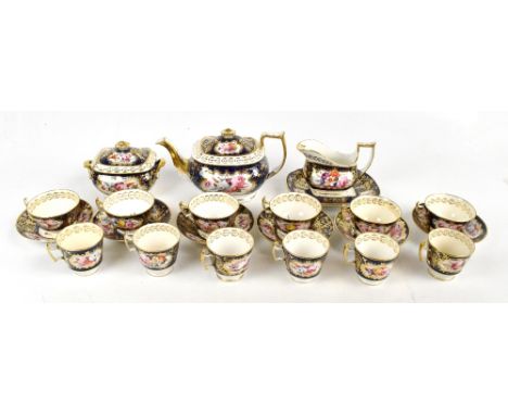 A 19th century twenty two piece tea service, possibly Spode decorated with hand-painted floral sprays inside gilt scrolling d