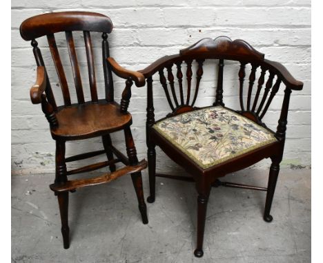 A 19th century elm seated child's high chair, raised on turned column supports, and an Edwardian inlaid mahogany corner chair