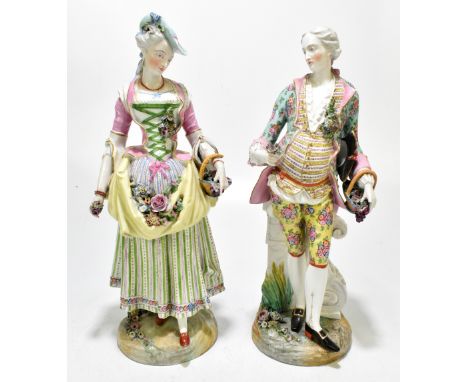 MEISSEN; a pair of late 19th century figures of a male and female companion in 18th century dress, each holding a basket and 